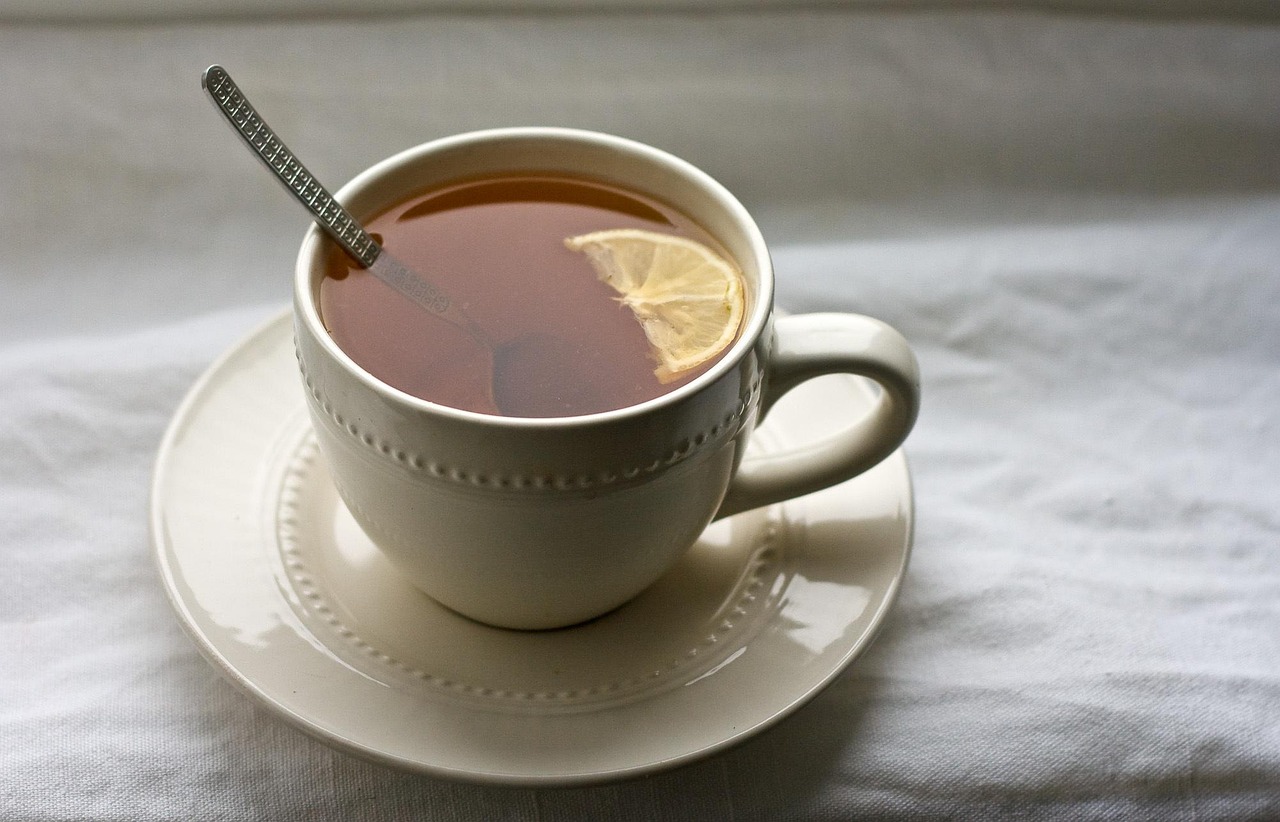 a cup of tea with a lemon slice